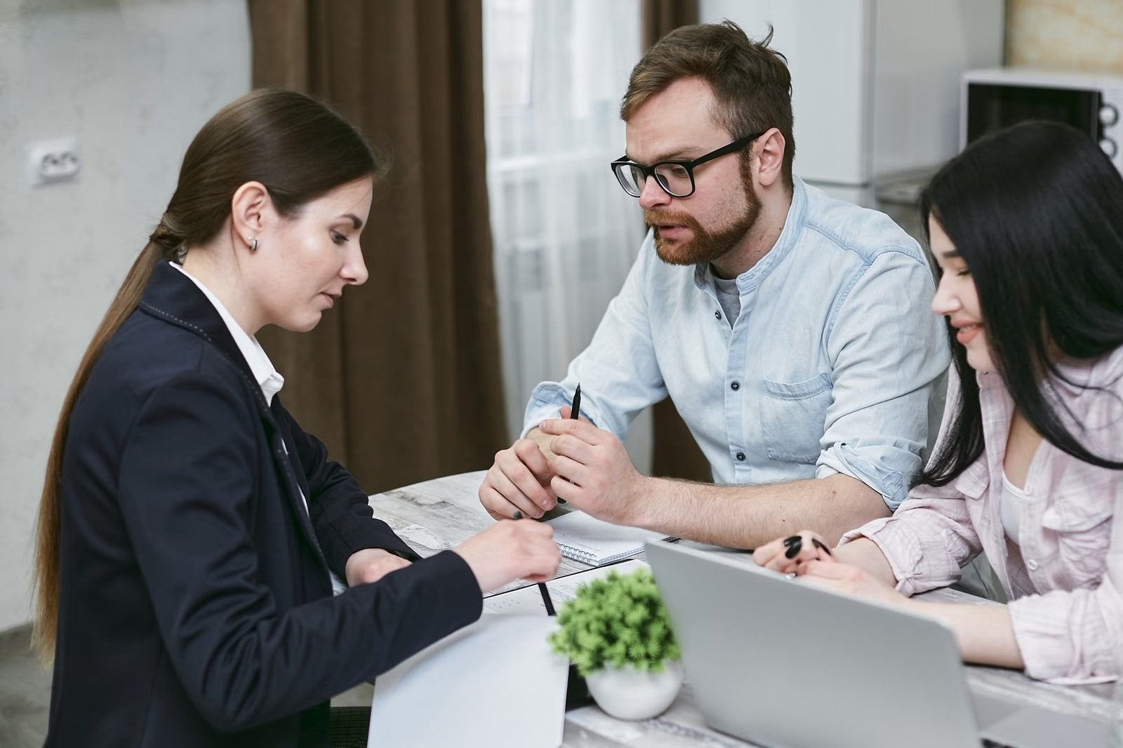 Financial advisor helping a young couple with their plan